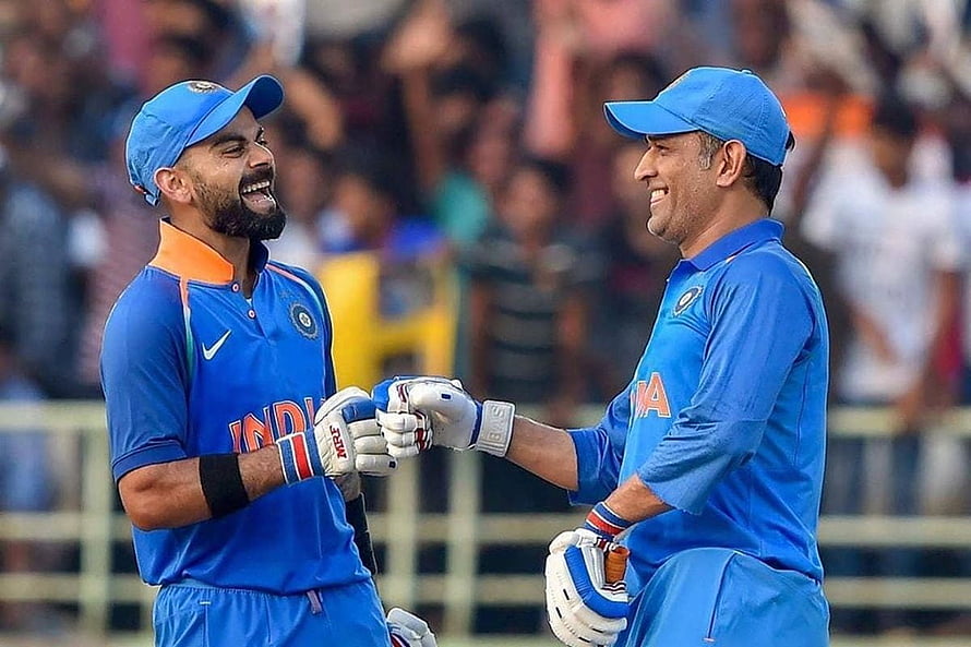 Virat Kohli and MS Dhoni Celebrate in Indian Cricket Blue ODI Uniforms HD wallpaper
