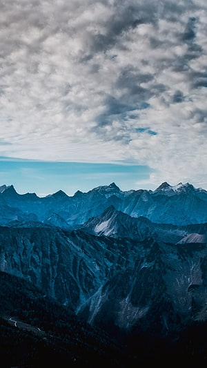 Dramatic Blue Mountain Range Under a Cloudy Sky HD phone wallpaper
