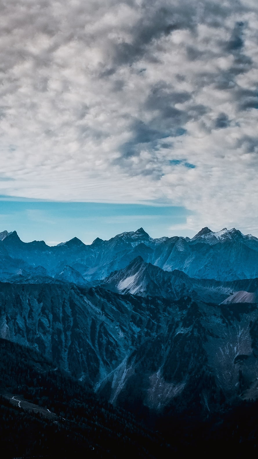 Dramatic Blue Mountain Range Under a Cloudy Sky HD phone wallpaper