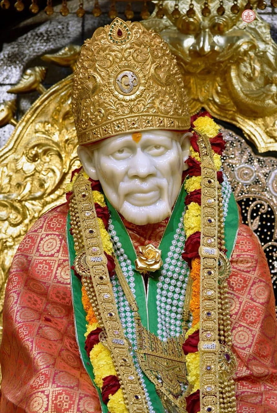 Decorated Statue of Sai Baba with Golden Crown and Flower Garlands HD phone wallpaper