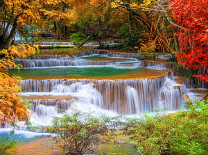 Vibrant Autumn Waterfall Cascading Through Colorful Forest Foliage HD wallpaper