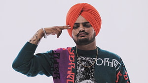 Sidhu Moose Wala Portrait Wearing Orange Turban and Colorful Sweater HD wallpaper