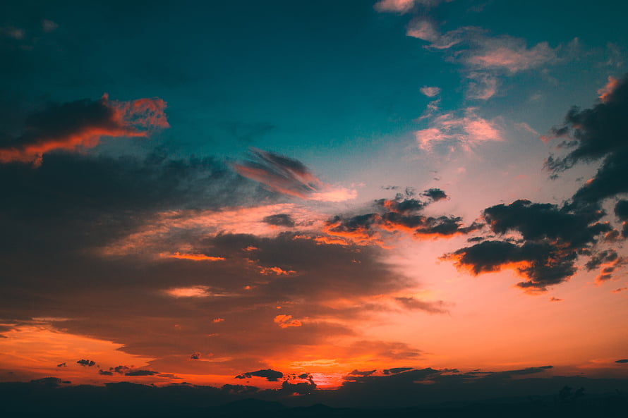 Dramatic Sunset Sky with Fiery Orange and Teal Clouds HD wallpaper