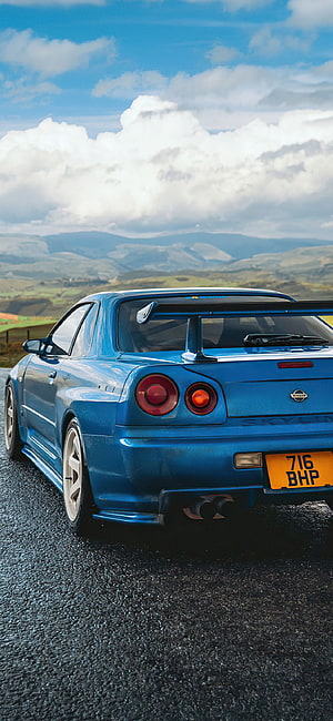 Blue Nissan Skyline GT-R R34 Rear View on Mountain Road HD phone wallpaper