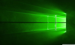 Glowing Green Windows 10 Logo on Dark Textured Wall HD wallpaper