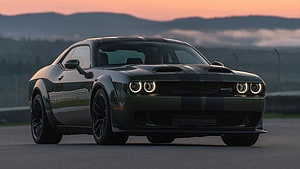 Dodge Challenger SRT Demon 170 in dark green with racing stripes on a track at sunset HD wallpaper