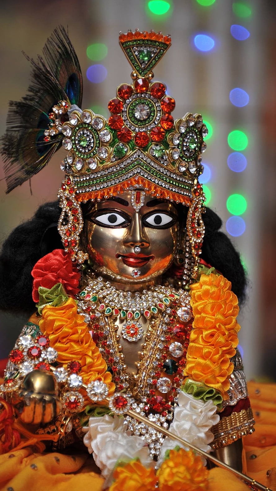 Ornate Golden Krishna Idol With Peacock Feather Crown And Jewels HD phone wallpaper