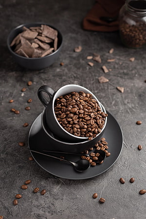 Dark Aesthetic Coffee Beans in Black Cup with Chocolate Pieces on Gray Background HD phone wallpaper