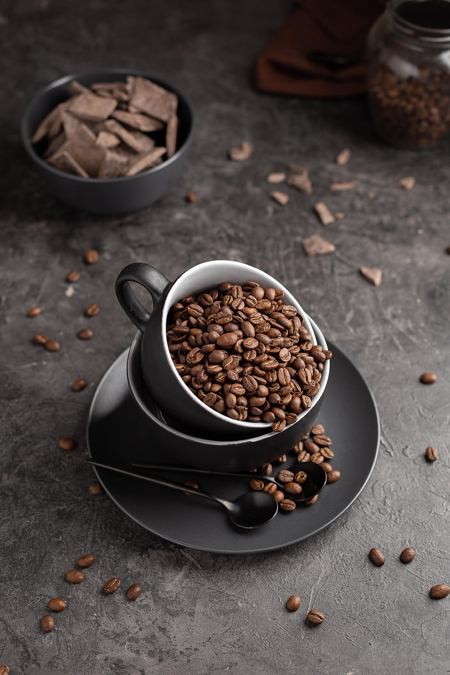 Dark Aesthetic Coffee Beans in Black Cup with Chocolate Pieces on Gray Background HD phone wallpaper