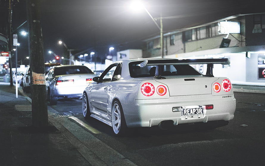 Silver Nissan Skyline GT-R R34 Rear View Parked on a Night Street HD wallpaper