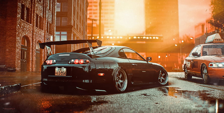 Black Toyota Supra MK4 with large rear wing parked on wet city street at sunset HD wallpaper