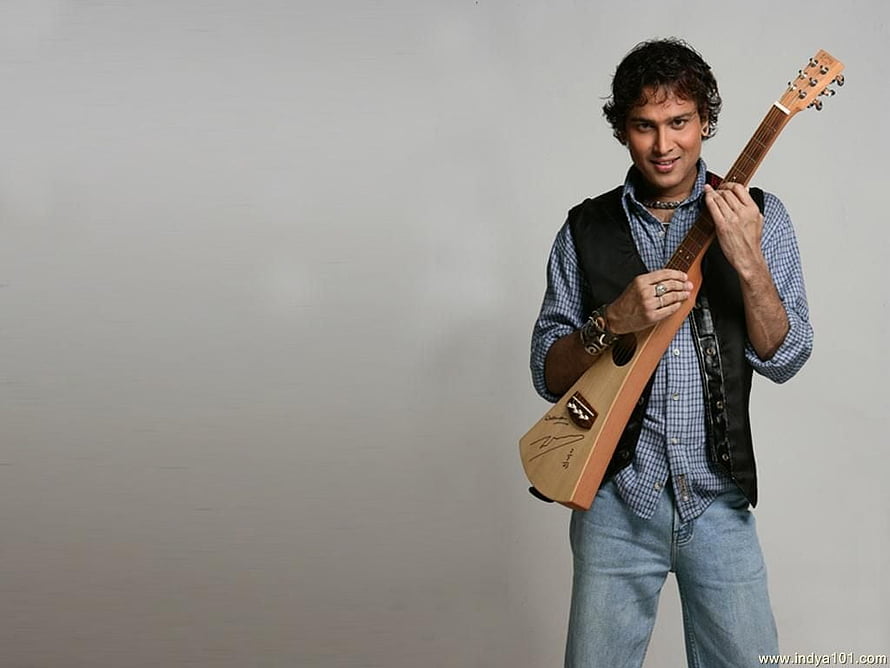 Zubeen Garg Holding Acoustic Guitar in Studio Portrait HD wallpaper