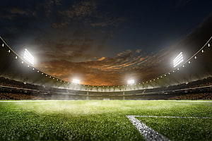 Empty Soccer Stadium at Dusk with Bright Floodlights and Lush Green Pitch HD wallpaper