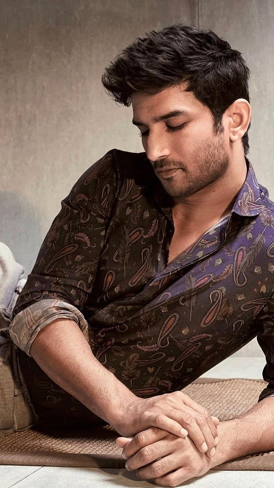 Sushant Singh Rajput in a moody portrait wearing a paisley patterned shirt with a contemplative expression HD phone wallpaper