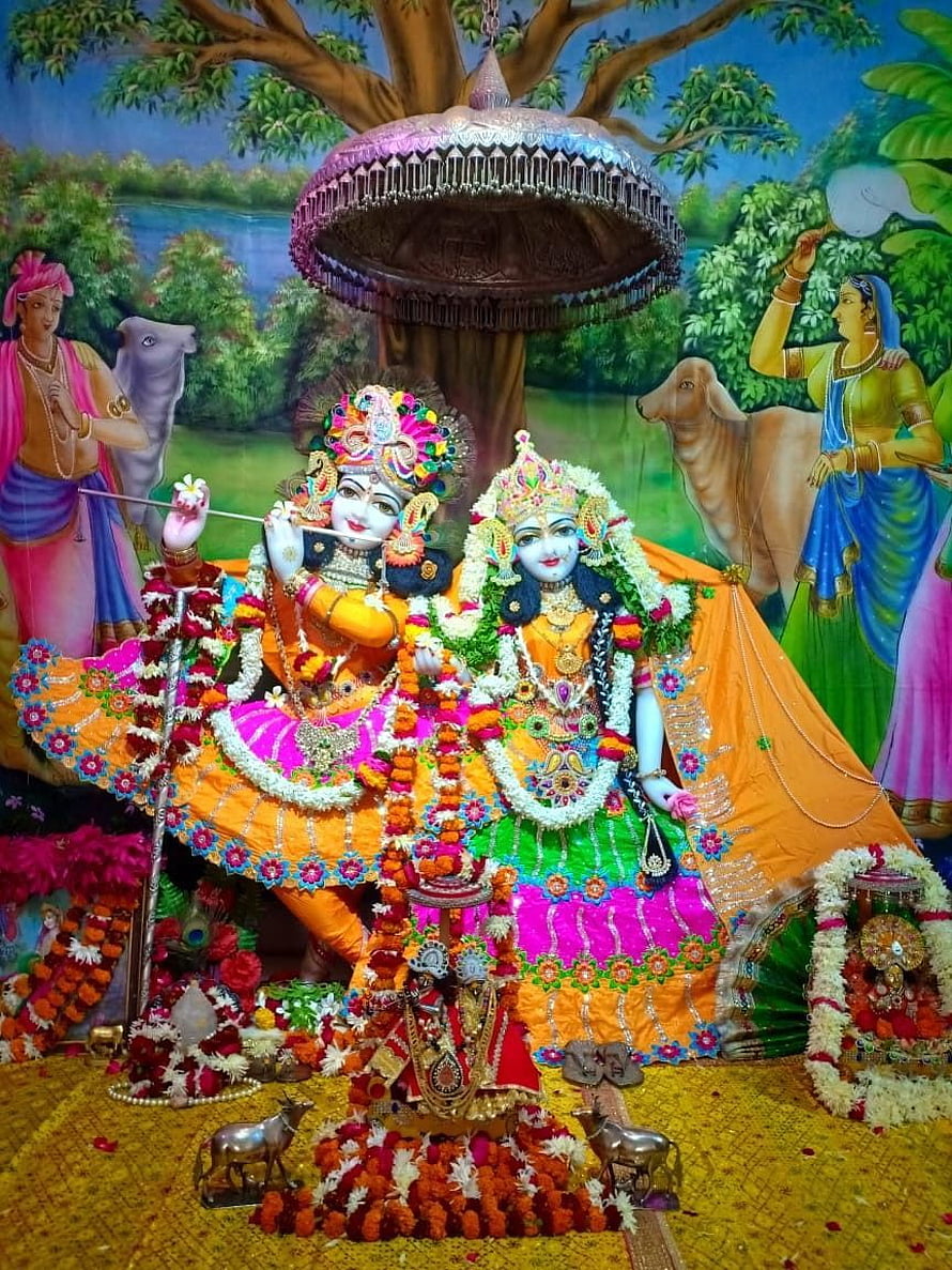 Vrindavan Temple Murti of Radha and Krishna Adorned with Marigold Garlands and Traditional Attire HD phone wallpaper