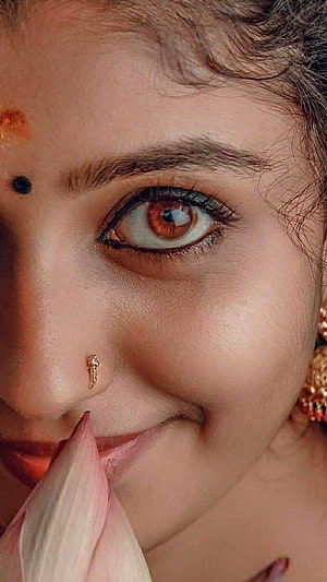 Close-up portrait of a woman with a bindi and nose stud holding a lotus flower, Kerala girl, kerala beauty, beautiful HD phone wallpaper