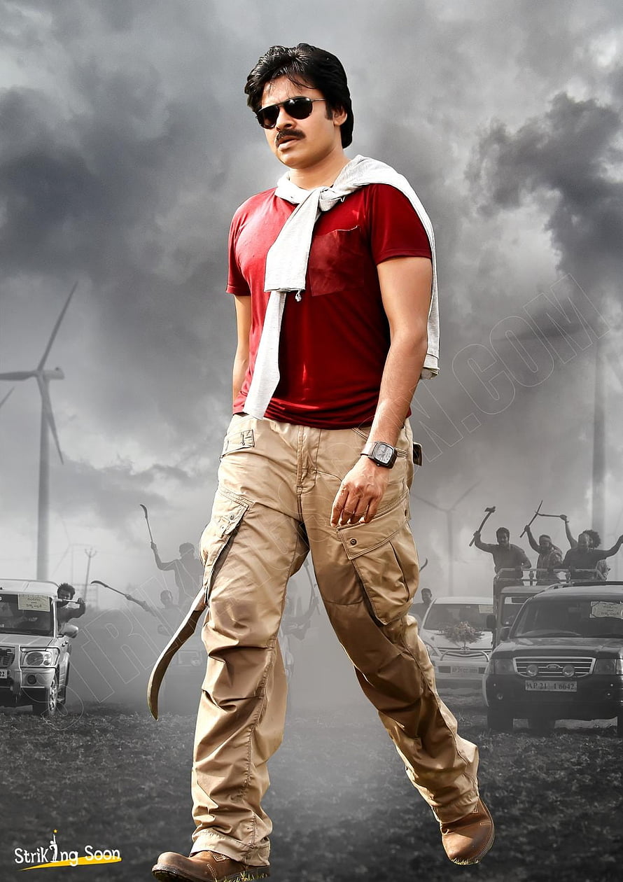 Pawan Kalyan in red t-shirt and cargo pants holding a sickle with stormy wind farm background HD phone wallpaper