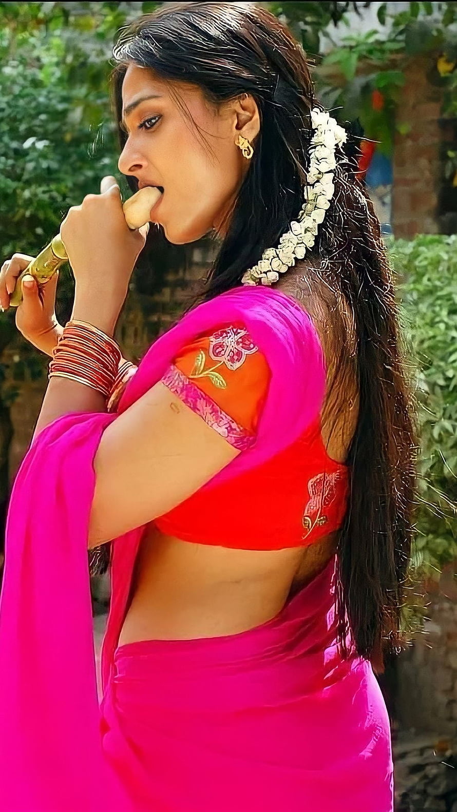 Anushka Shetty in Vibrant Pink Saree with Traditional Floral Hairpiece HD phone wallpaper