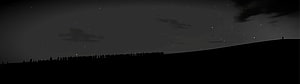 Silhouetted Crowd on a Hill Under a Starry Night Sky HD wallpaper