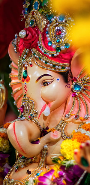 Ornate Ganesha Idol With Jeweled Crown And Floral Garlands HD phone wallpaper
