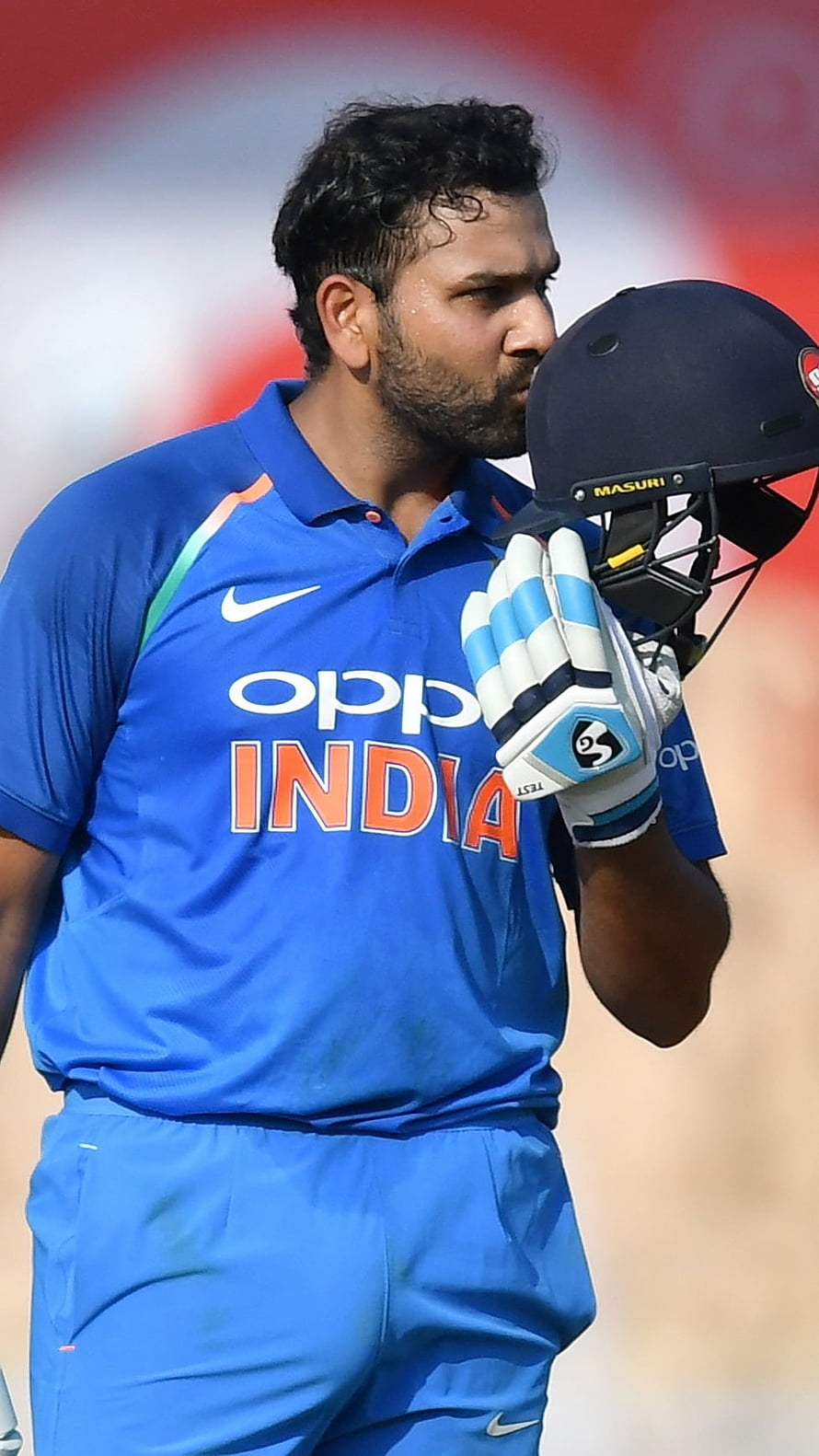 Rohit Sharma in India Cricket Jersey Holding Helmet on the Field HD phone wallpaper