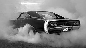 Black Dodge Charger Classic Muscle Car Performing Burnout in Smoke HD wallpaper