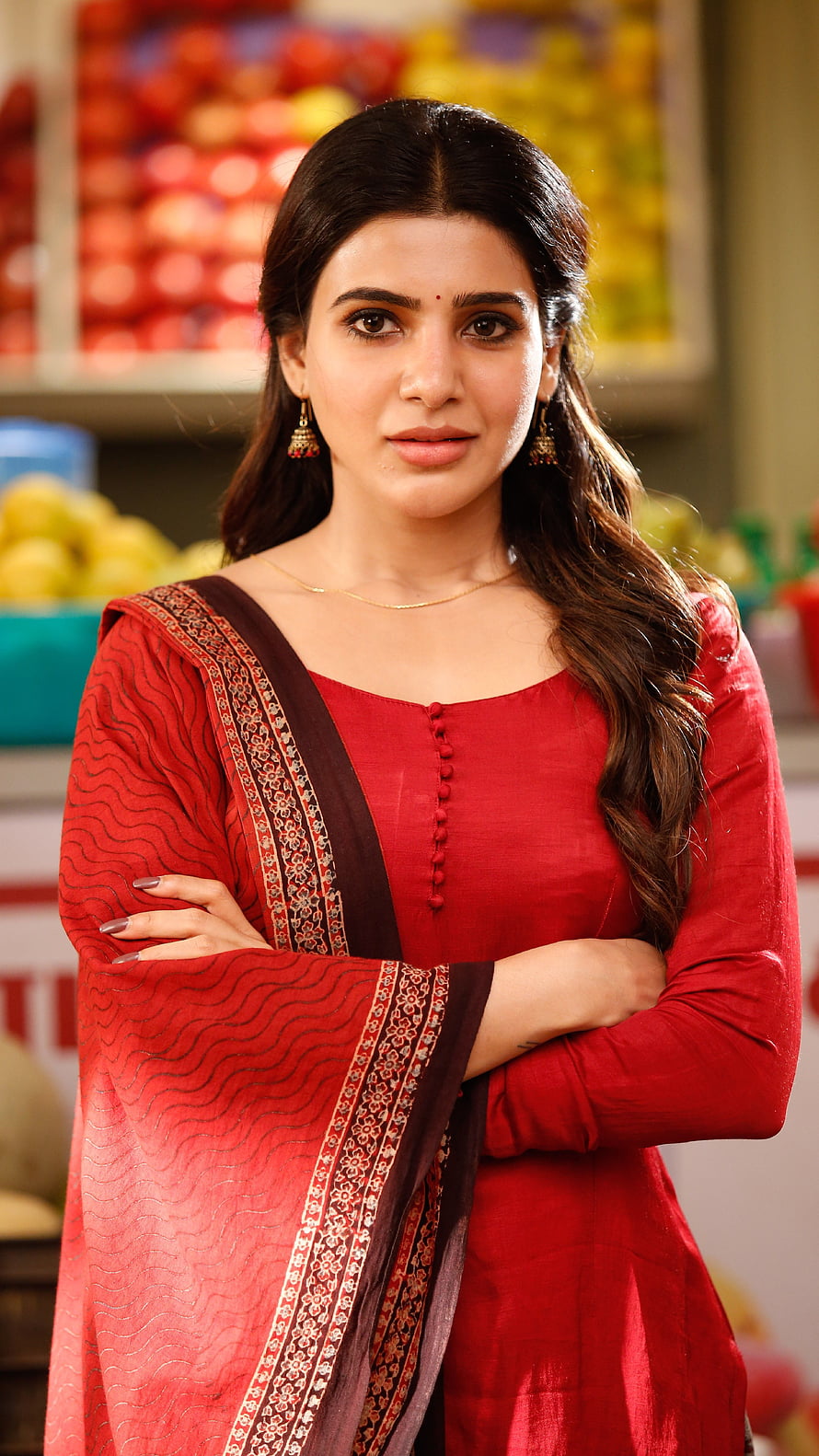 Saiyami Kher in a red salwar kameez with arms crossed in a grocery store setting HD phone wallpaper