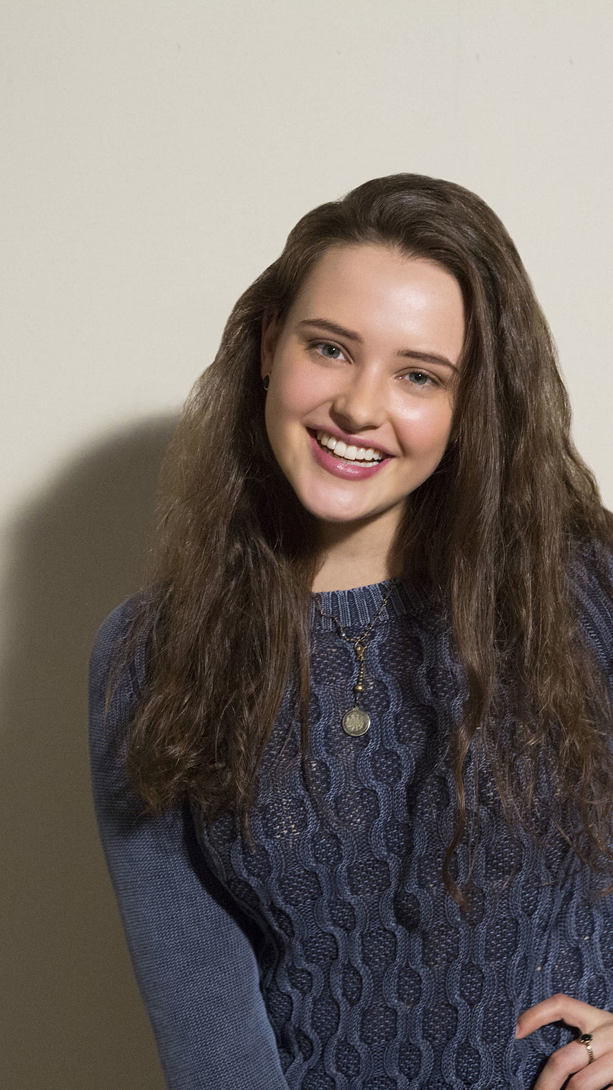 Katherine Langford smiling portrait in a textured navy blue knit sweater HD phone wallpaper
