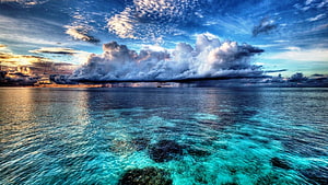 Tropical Lagoon with Turquoise Water, Coral Reefs, and Dramatic Storm Clouds at Sunset HD wallpaper