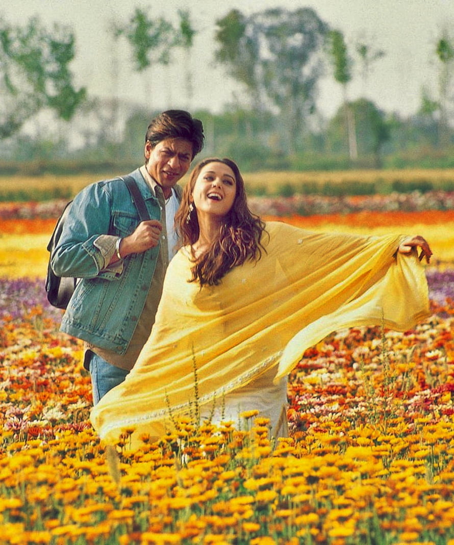 Veer Zaara Movie Scene: Couple Dancing in a Vibrant Marigold Flower Field HD phone wallpaper