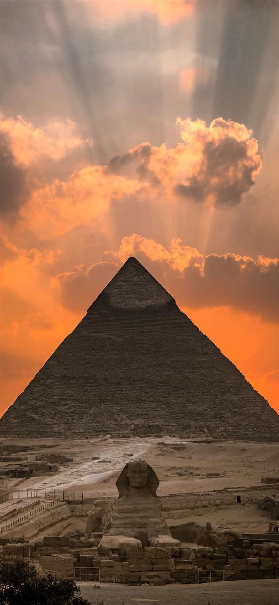 Great Pyramid of Giza and Sphinx at Sunset with Dramatic Clouds and Light Rays HD phone wallpaper