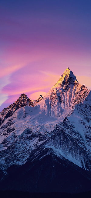 Majestic Snow-Capped Mountain Peak Illuminated by Golden Sunrise Against a Vibrant Purple and Pink Sky HD phone wallpaper