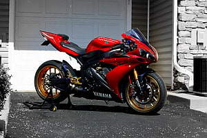 Red Yamaha R1 Sportbike with Gold Wheels Parked in Front of a Garage HD wallpaper