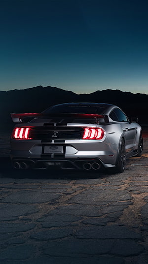 Silver Ford Mustang Shelby GT500 Rear View with Triple-Bar Taillights and Racing Stripes at Dusk HD phone wallpaper