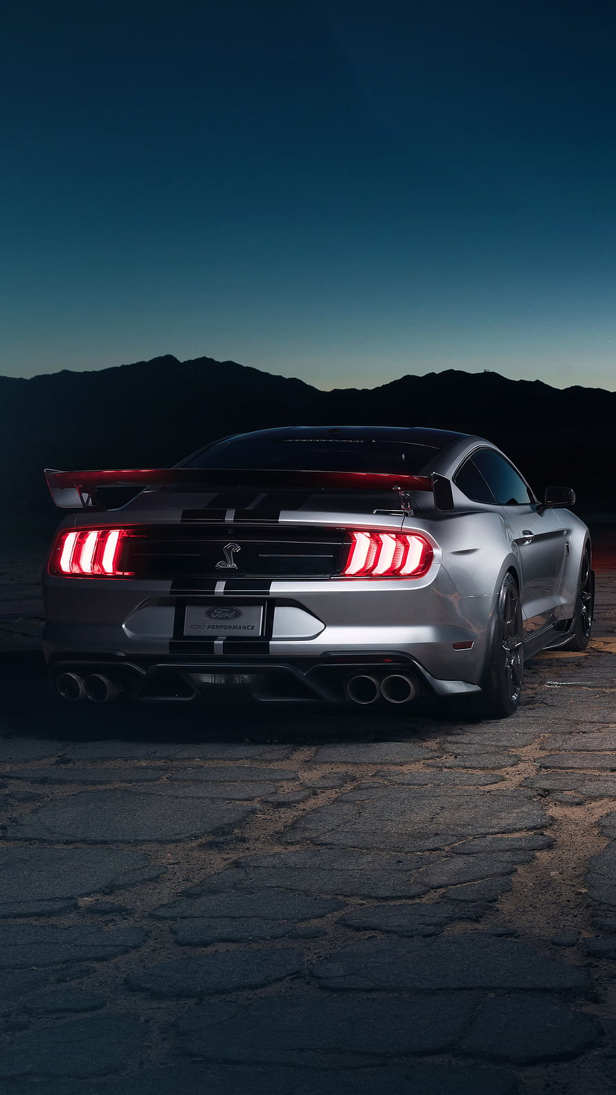 Silver Ford Mustang Shelby GT500 Rear View with Triple-Bar Taillights and Racing Stripes at Dusk HD phone wallpaper