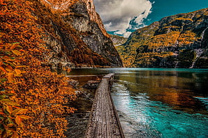 Autumnal Lake Scene With Weathered Wooden Dock And Vibrant Foliage HD wallpaper
