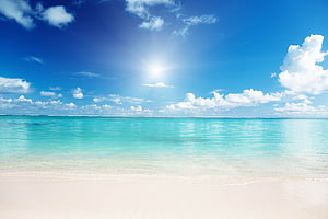 Serene Tropical Beach With Turquoise Water And White Sand Under A Bright Blue Sky HD wallpaper