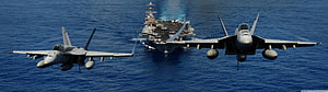 US Navy F-18 Super Hornets in Formation Over Aircraft Carrier on Open Ocean HD wallpaper