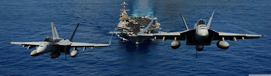 US Navy F-18 Super Hornets in Formation Over Aircraft Carrier on Open Ocean HD wallpaper