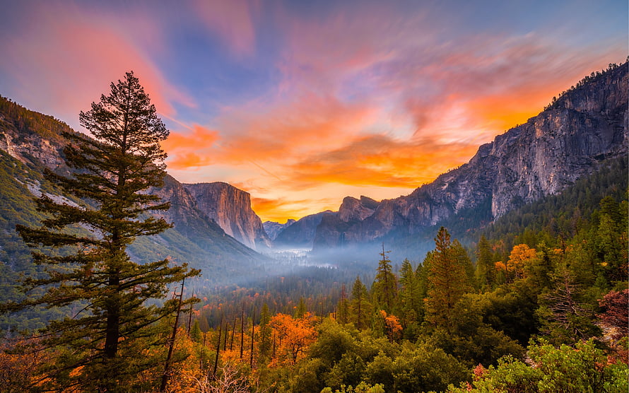 Yosemite National Park Valley at Sunset with Dramatic Orange Sky and Misty Forest HD wallpaper