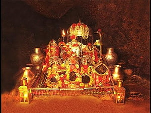 Maa Vaishno Devi Shrine Adorned With Marigold Garlands And Oil Lamps In A Sacred Cave HD wallpaper