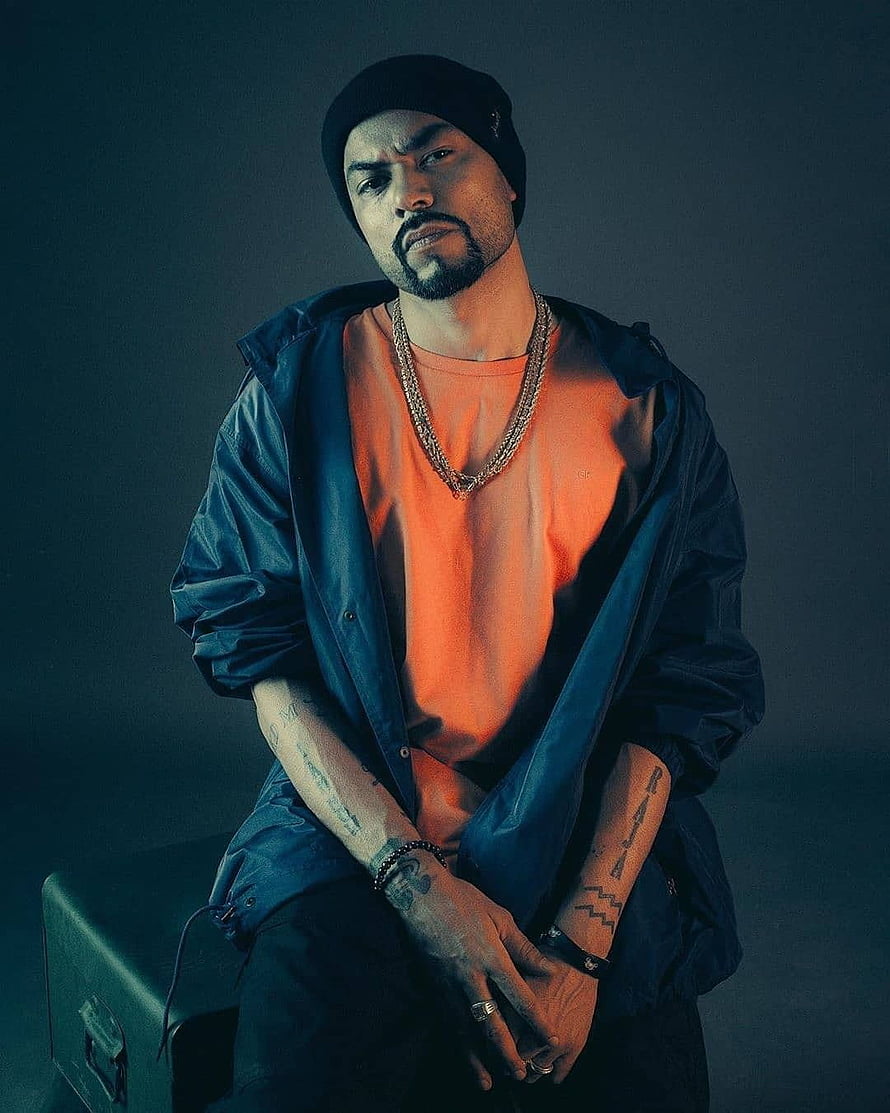 Bohemia Punjabi Rapper Studio Portrait in Orange Tee and Beanie HD phone wallpaper
