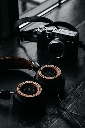 Grado RS2e Reference Series Headphones and Vintage Camera on Dark Wood Surface HD phone wallpaper