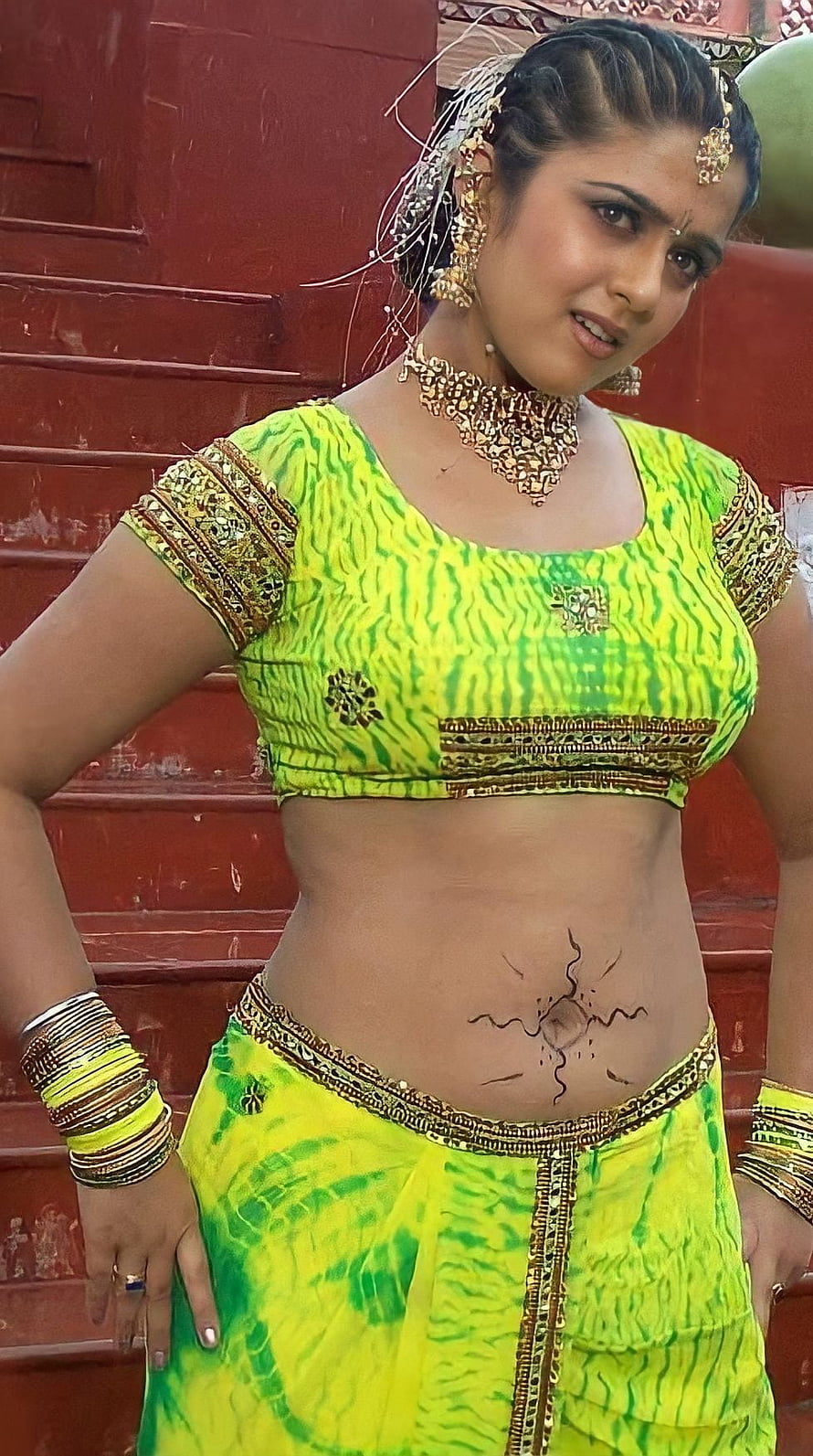 Woman in vibrant green tie-dye traditional outfit with gold jewelry and belly art, Charmi Kaur, telugu actress, navel HD phone wallpaper