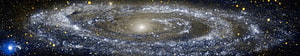 Spiral Galaxy with Bright Core and Dust Lanes in Deep Space HD wallpaper