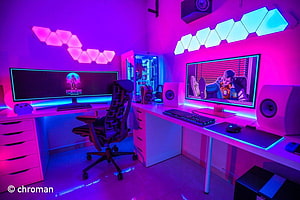 Vibrant Neon Gaming Setup with Dual Monitors and RGB Hexagon Lights HD wallpaper