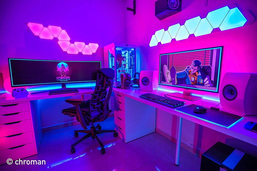 Vibrant Neon Gaming Setup with Dual Monitors and RGB Hexagon Lights HD wallpaper