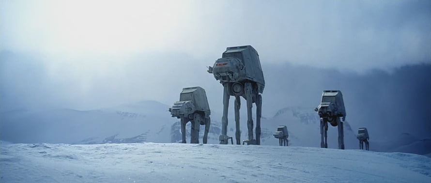 AT-AT Walkers Marching Across Snowy Terrain in Star Wars The Empire Strikes Back HD wallpaper