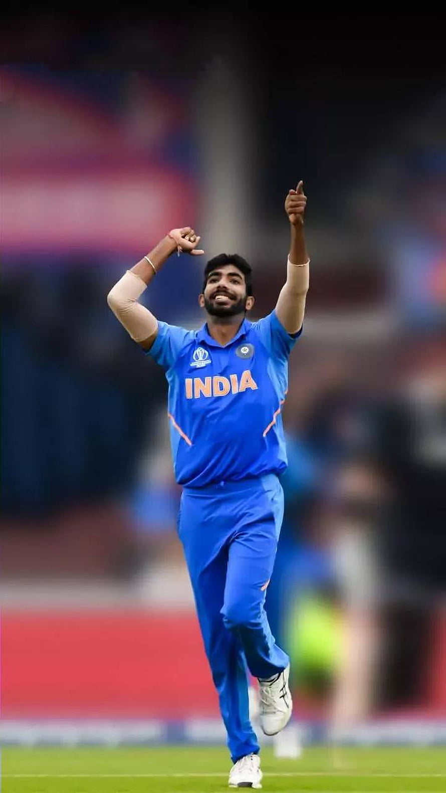 Jasprit Bumrah Celebrating in India Cricket Jersey on the Field HD phone wallpaper