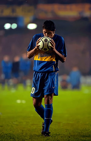 Lionel Messi in Boca Juniors Kit Holding Soccer Ball on Pitch HD phone wallpaper